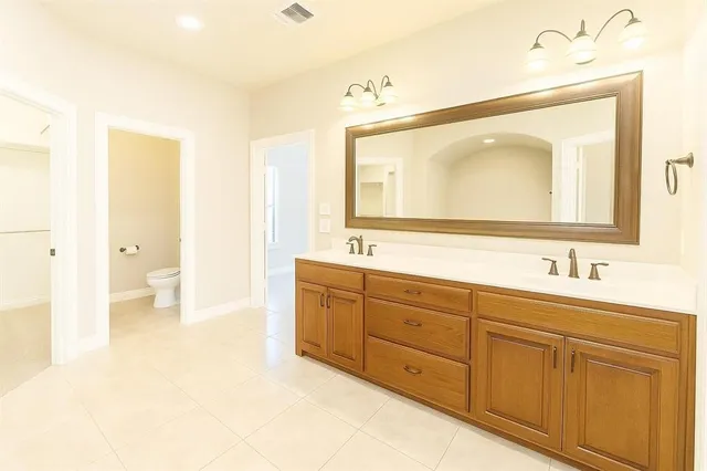 a spacious bathroom with a double vanity sink mirror and
