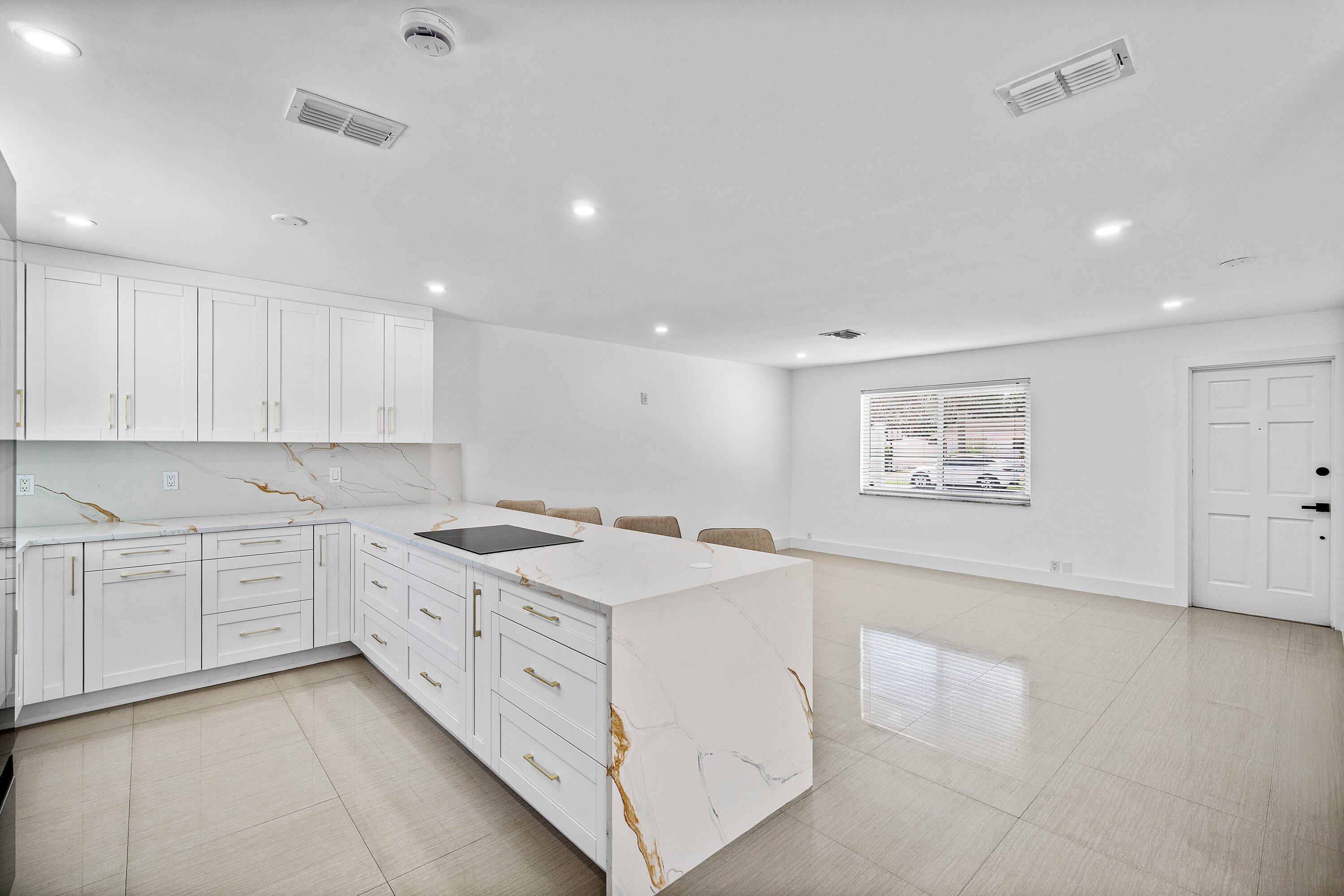 1531 Northwest 4th Street Boca Raton, FL 33486 - Photo 5 of 34 a kitchen with a stove microwave and cabinets