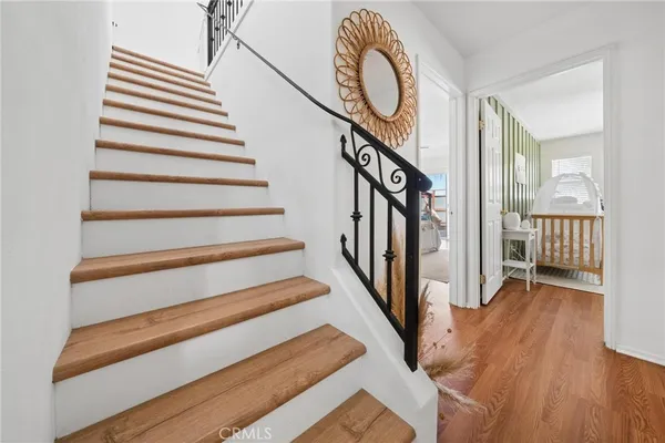 a view of entryway and hall with wooden floor