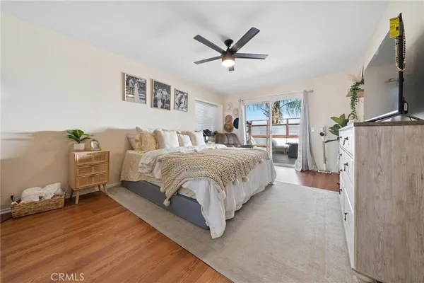 a spacious bedroom with a bed and a flat screen tv