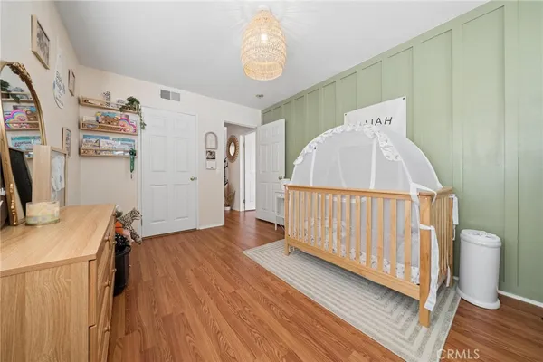 a view of a hardwood floor and closet in a room