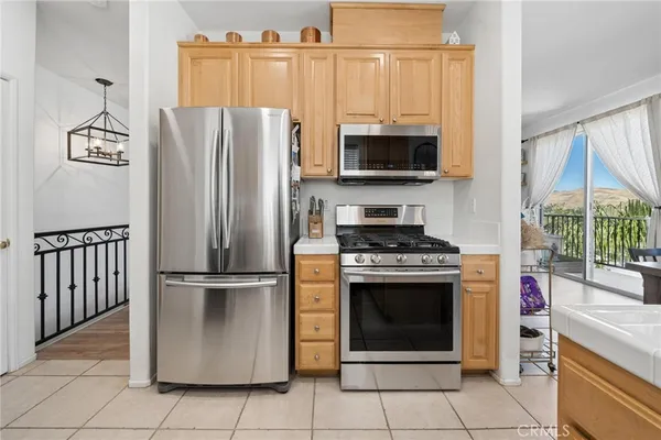 a kitchen with stainless steel appliances granite countertop a refrigerator stove and microwave
