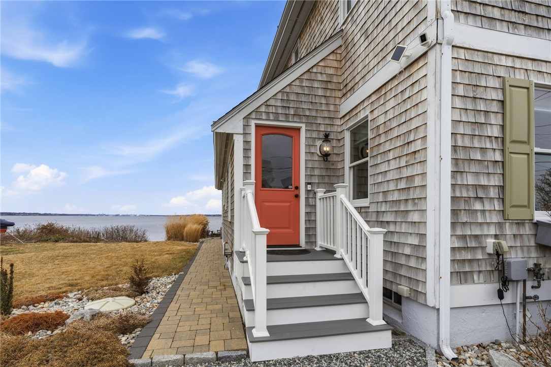 360 Shawomet Avenue Warwick, RI 02889 - Photo 5 of 47 Side porch with updated trex decking and vinyl handrails, paver walkway to the back patio