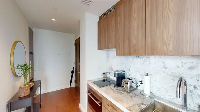 a kitchen with stainless steel appliances a sink a counter space and a window
