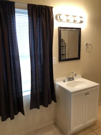 a white toilet sitting next to a bathroom sink