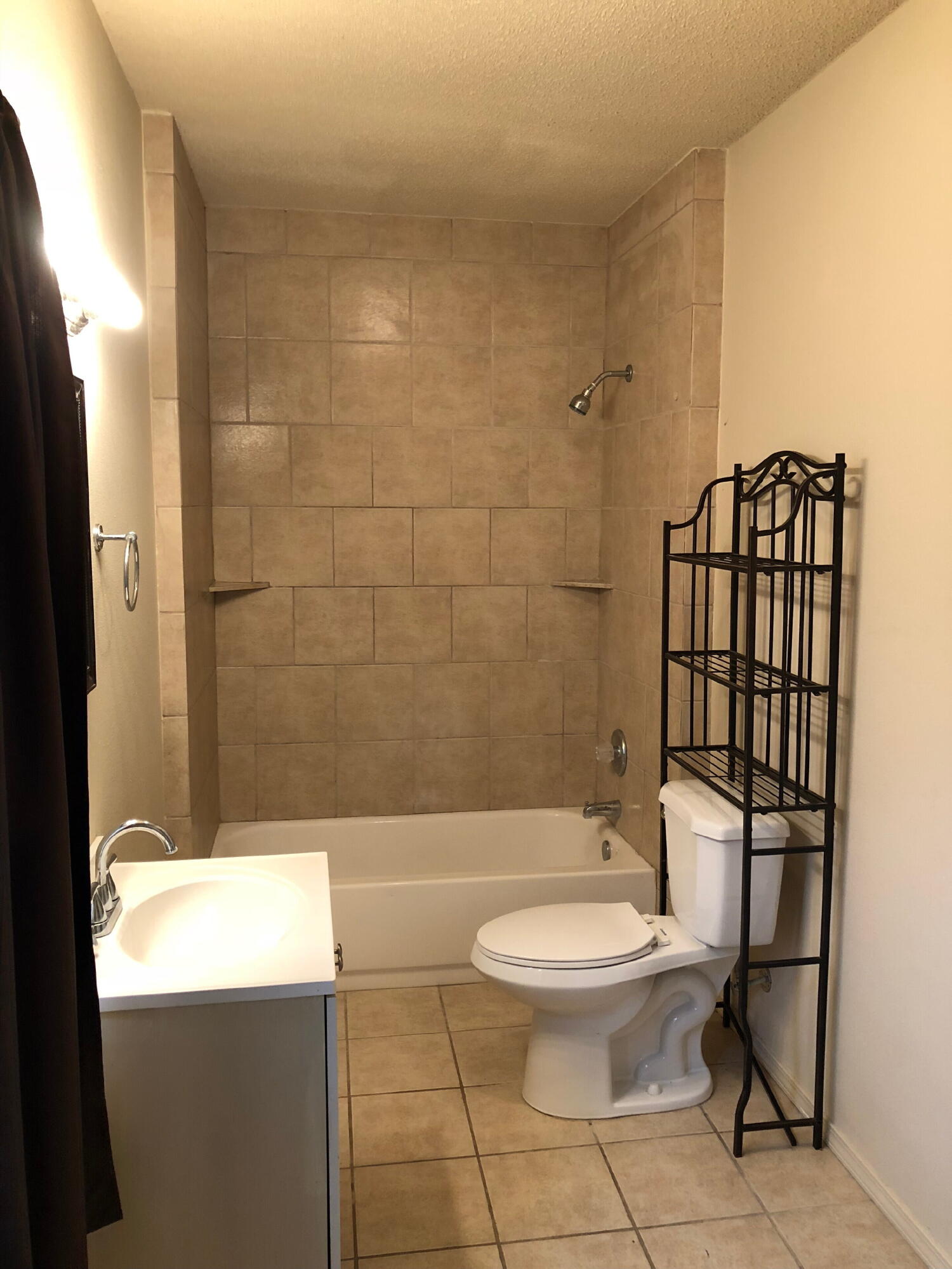 3020 45th Street Lubbock, TX 79413 - Photo 19 of 20 a white toilet sitting next to a bathroom sink