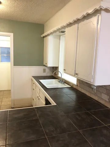 a view of a bathroom with a sink and a mirror