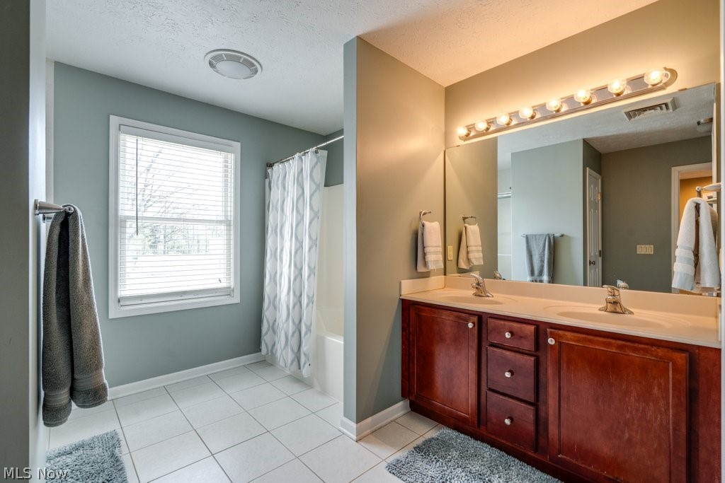 6325 Brecksville Road Independence, OH 44131 - Photo 33 of 50 The property features a bathroom with a double vanity, a large mirror, and ample lighting