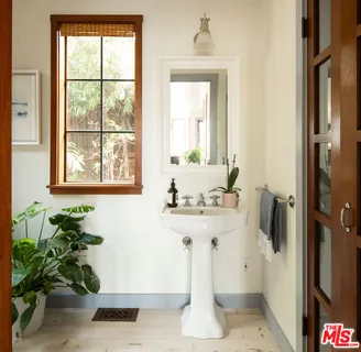 a bathroom with a sink a mirror and a window