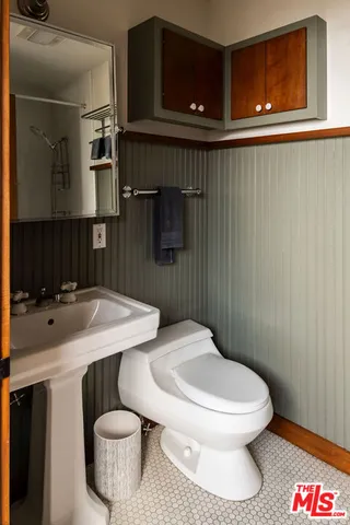 a white toilet sitting next to a bathroom sink
