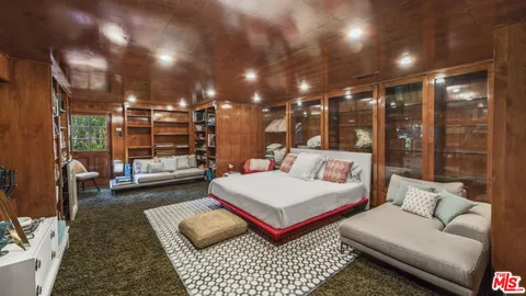 a living room with furniture a rug and white walls