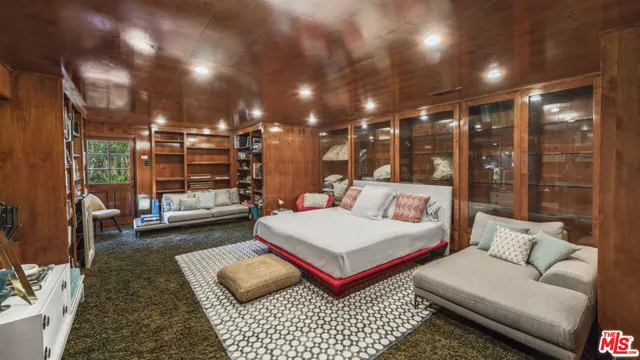 a living room with furniture a rug and white walls