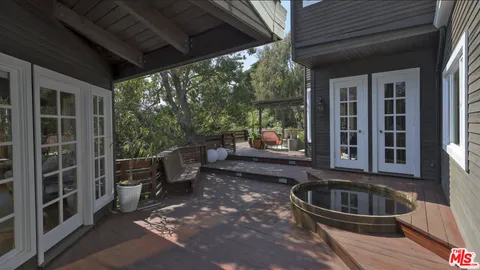 a view of a porch with furniture and floor to ceiling window