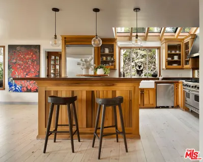 a kitchen with a table chairs stove and refrigerator
