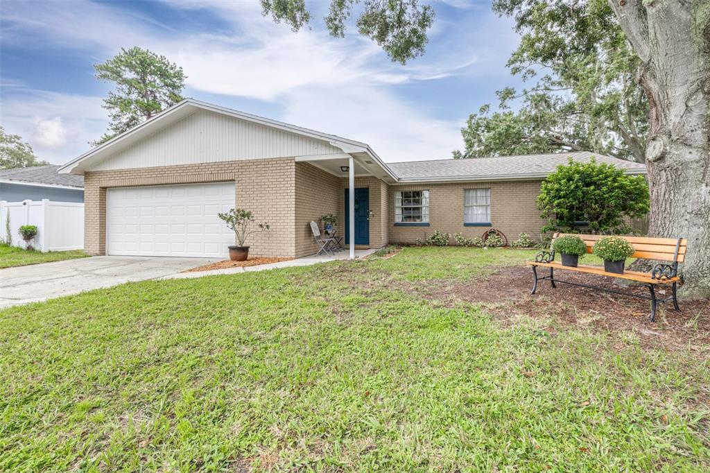 a view of a house with backyard and sitting area