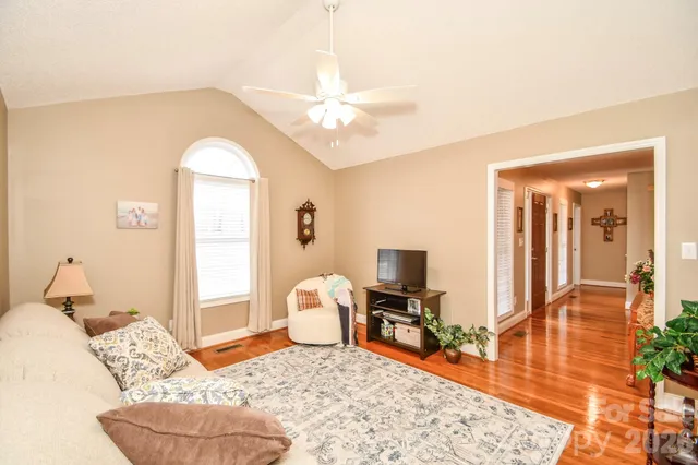 a kitchen with granite countertop a sink a stove and a wooden cabinets