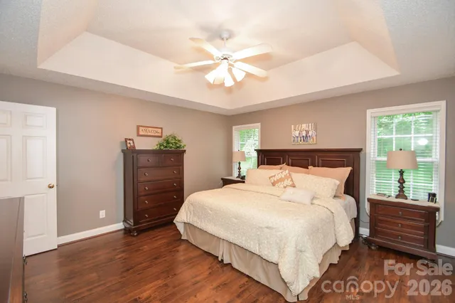 a bathroom with a granite countertop tub sink double vanity and shower