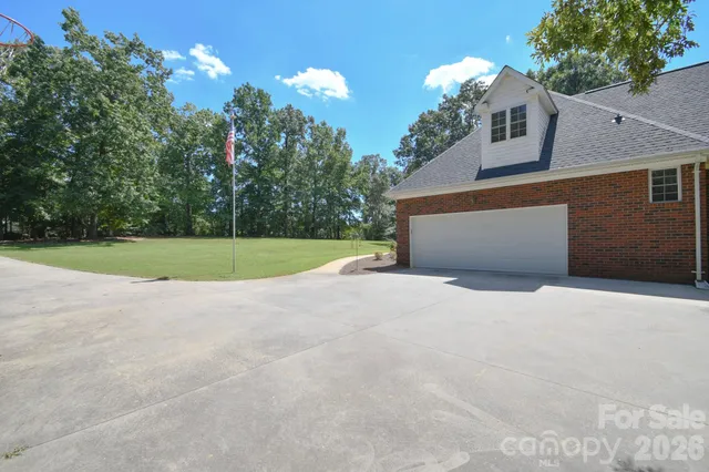 a view of a house with a yard and garage