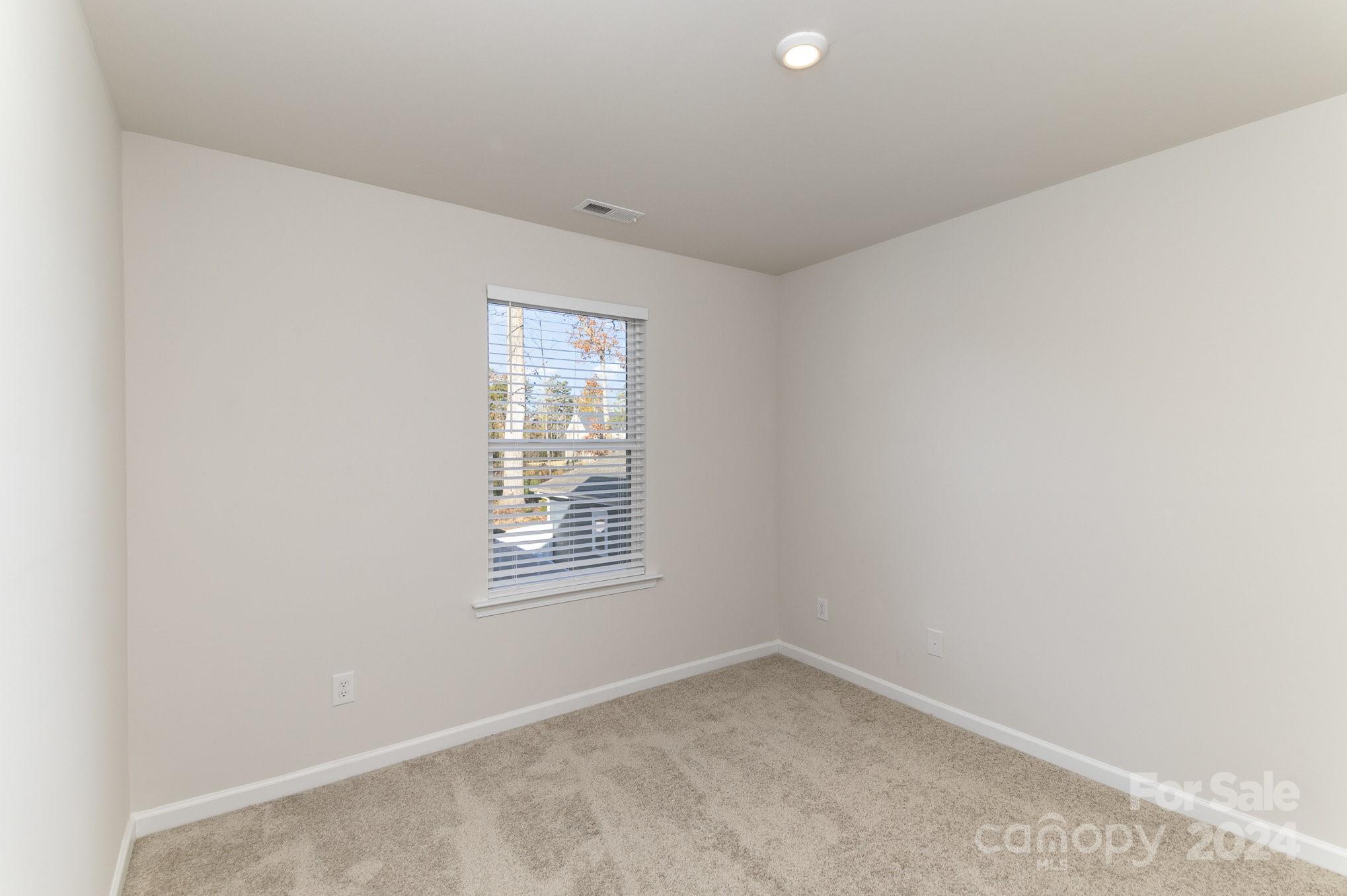 9130 Ramsford Road Charlotte, NC 28227 - Photo 13 of 18 an empty room with a window