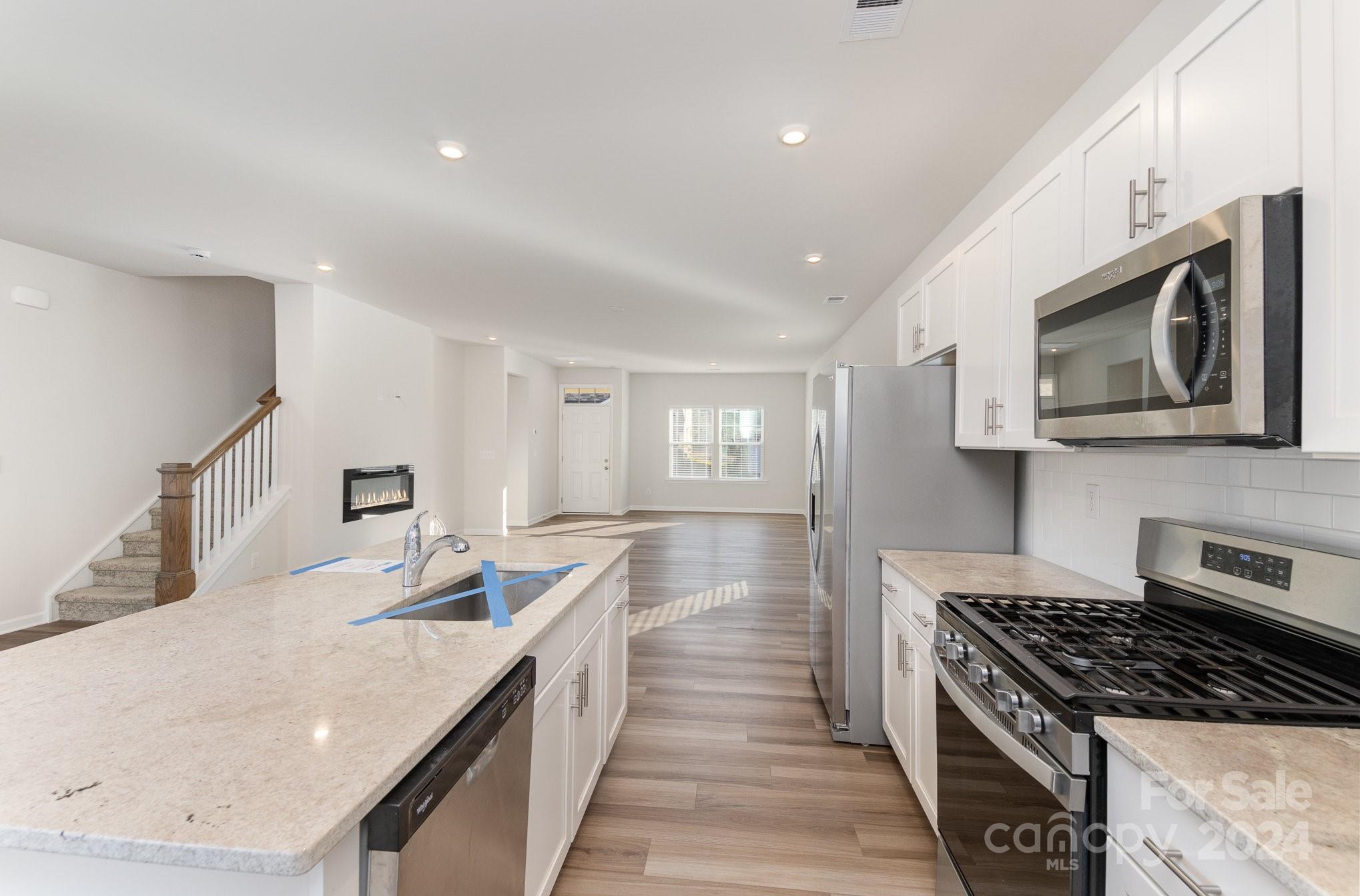 9130 Ramsford Road Charlotte, NC 28227 - Photo 7 of 18 a kitchen with stainless steel appliances granite countertop a sink stove and microwave