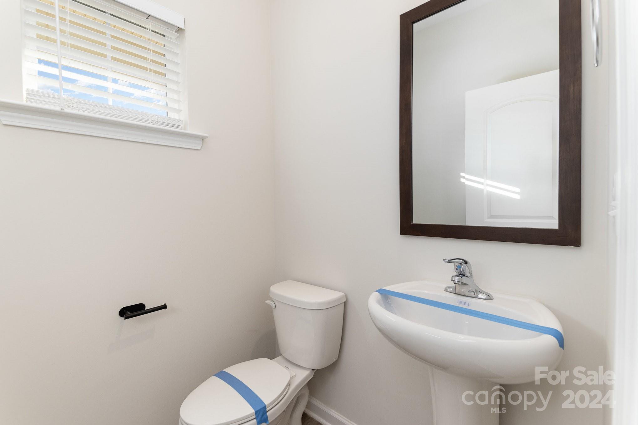9130 Ramsford Road Charlotte, NC 28227 - Photo 8 of 18 a bathroom with a toilet sink and mirror