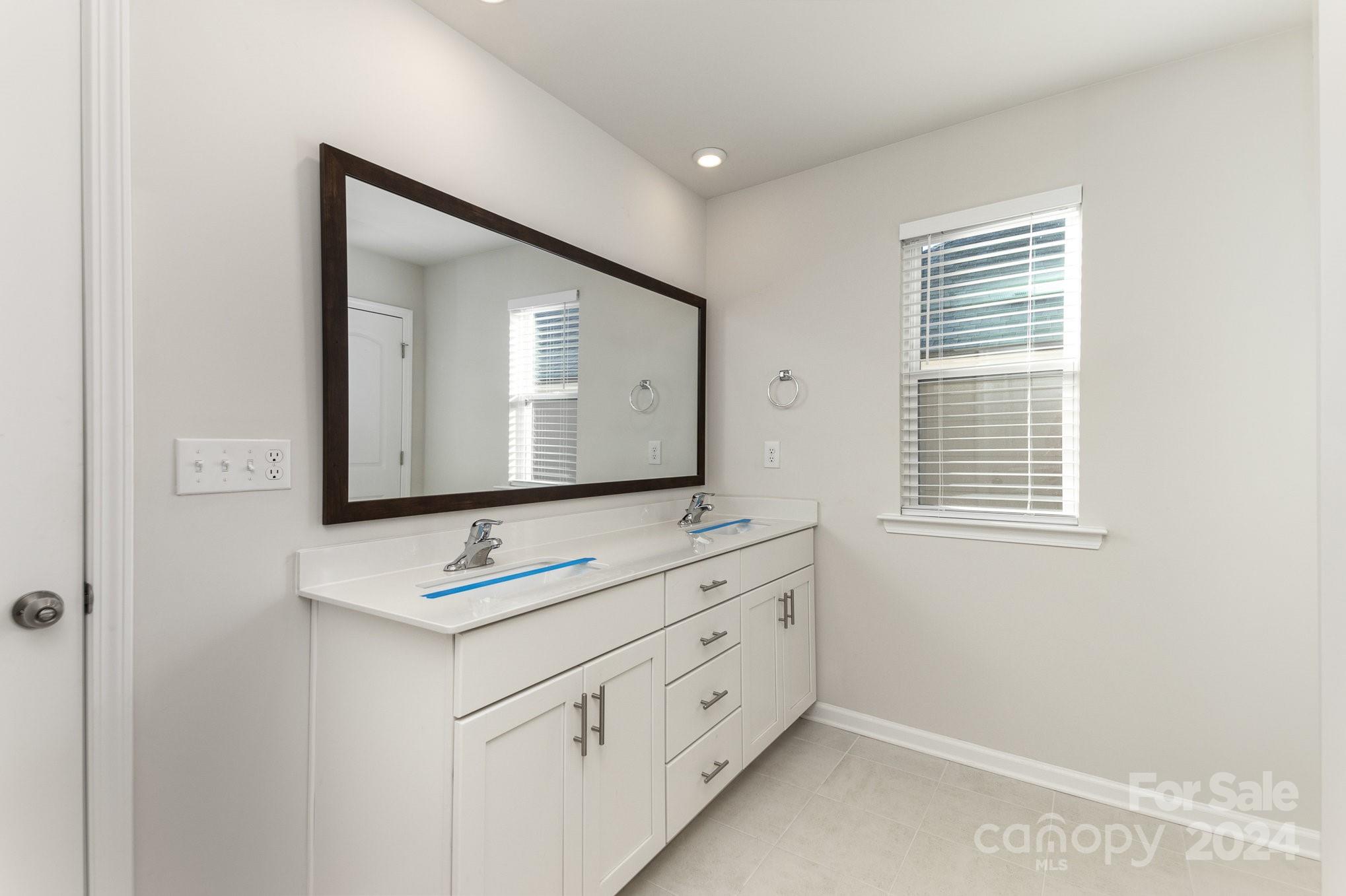 9130 Ramsford Road Charlotte, NC 28227 - Photo 10 of 18 a bathroom with 2 sink and a mirror