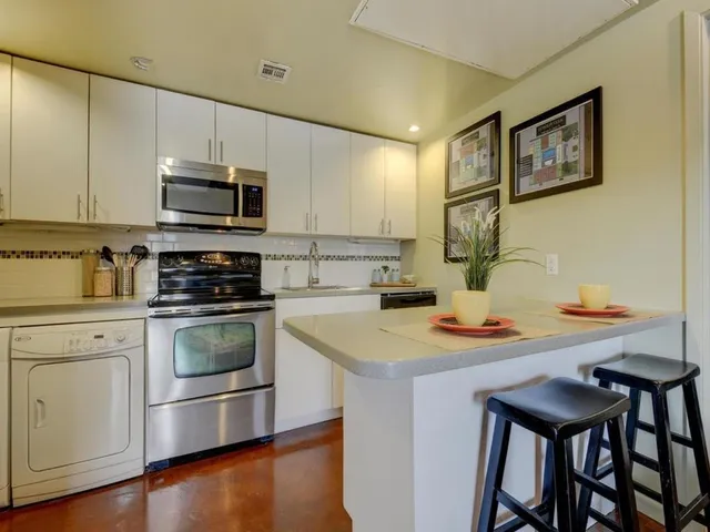 a kitchen with a stove a sink and a microwave