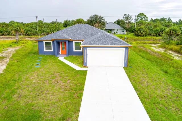 a view of a swimming pool with a yard