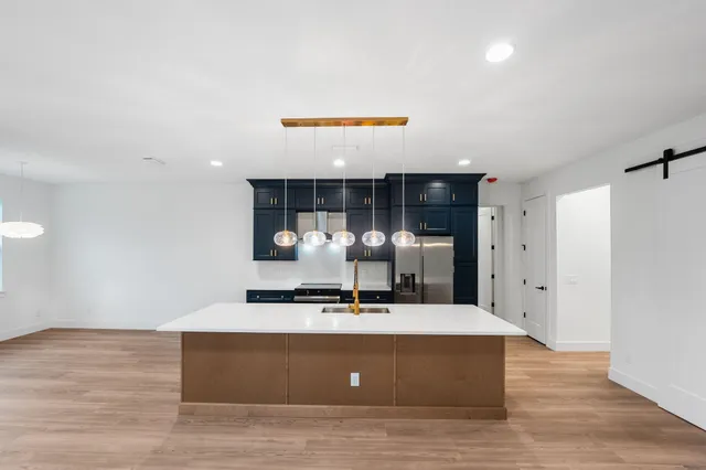 a room with wooden floor and glass door