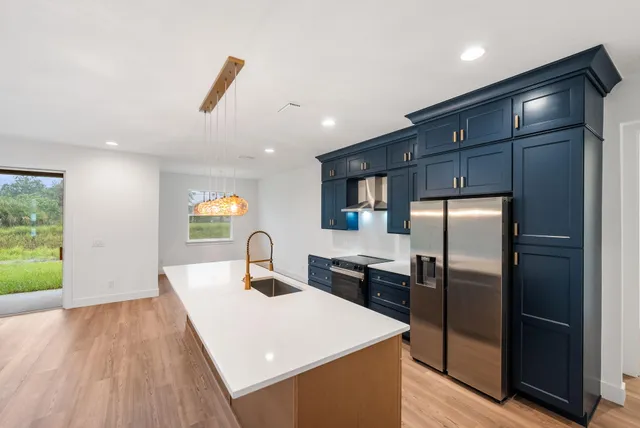 a kitchen with stainless steel appliances a refrigerator and a sink