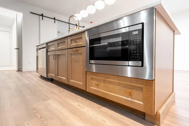 a kitchen with stainless steel appliances granite countertop a refrigerator and a stove