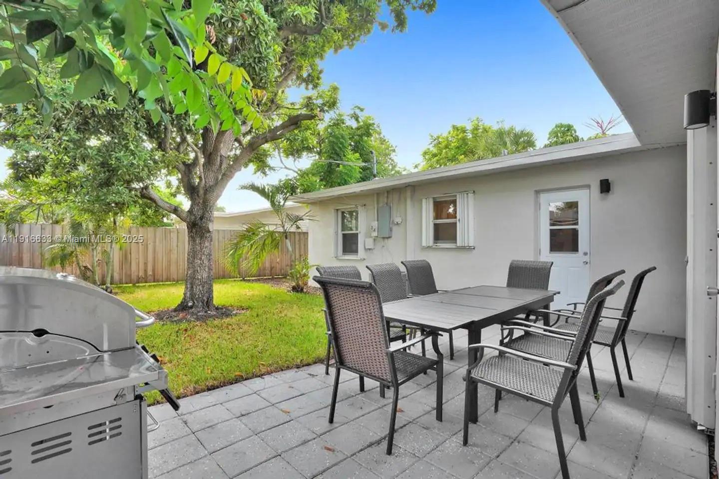 1573 Northeast 30th Court Pompano Beach, FL 33064 - Photo 13 of 27 a view of a chairs and table in backyard of the house