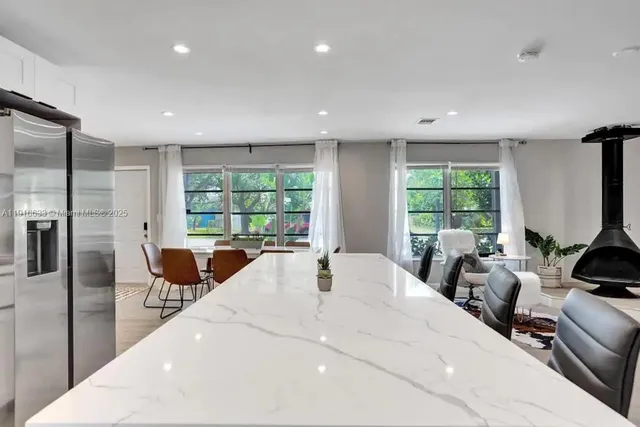 a kitchen with cabinets stainless steel appliances and a sink