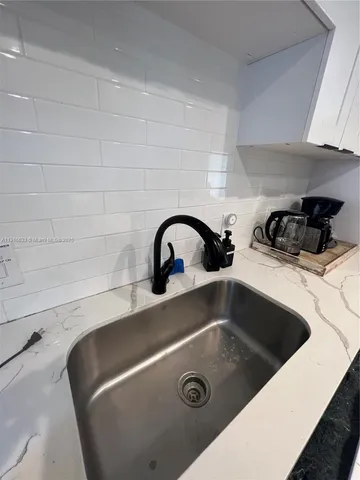 a kitchen with stainless steel appliances a stove a table and chairs