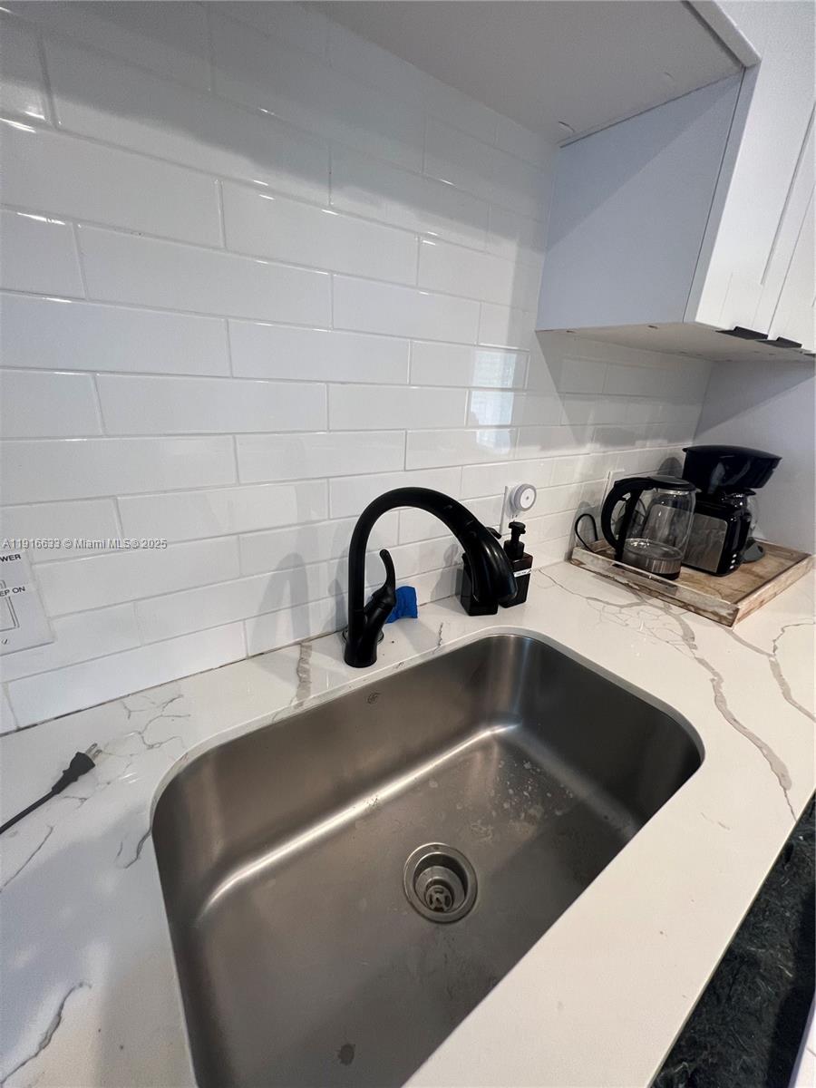 1573 Northeast 30th Court Pompano Beach, FL 33064 - Photo 19 of 27 a close view of sink and tap