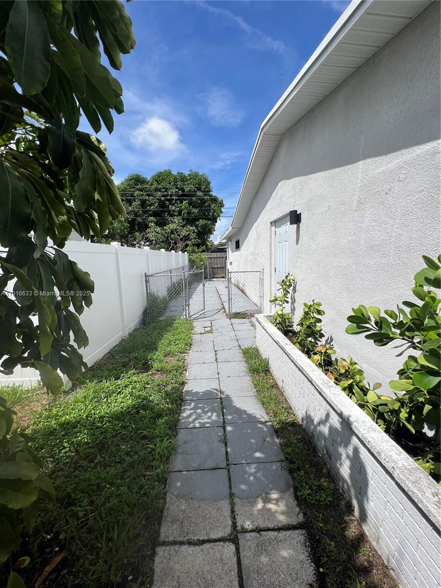 1573 Northeast 30th Court Pompano Beach, FL 33064 - Photo 22 of 27 a view of a pathway with a yard