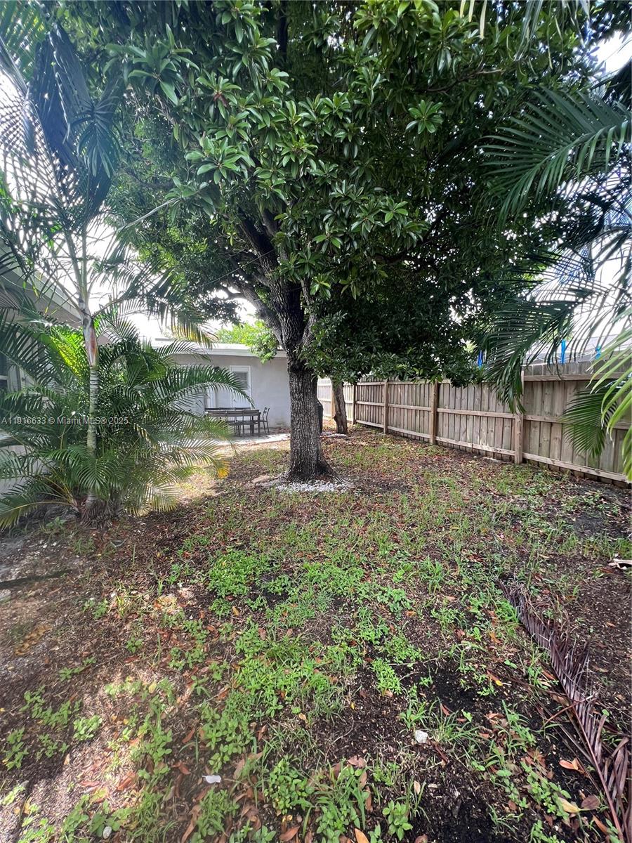 1573 Northeast 30th Court Pompano Beach, FL 33064 - Photo 23 of 27 a backyard of a house with lots of green space