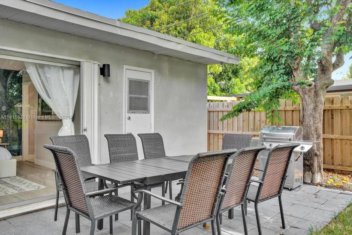 1573 Northeast 30th Court Pompano Beach, FL 33064 - Photo 4 of 27 a view of a patio with table and chairs and potted plants