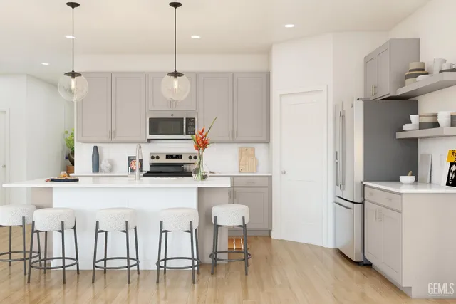 a view of a kitchen with furniture and wooden floor