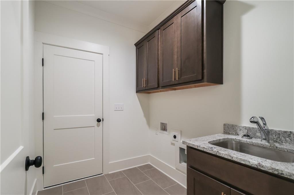 2113 Stonegate Way Monroe, GA 30656 - Photo 20 of 43 a bathroom with a granite countertop sink and cabinets