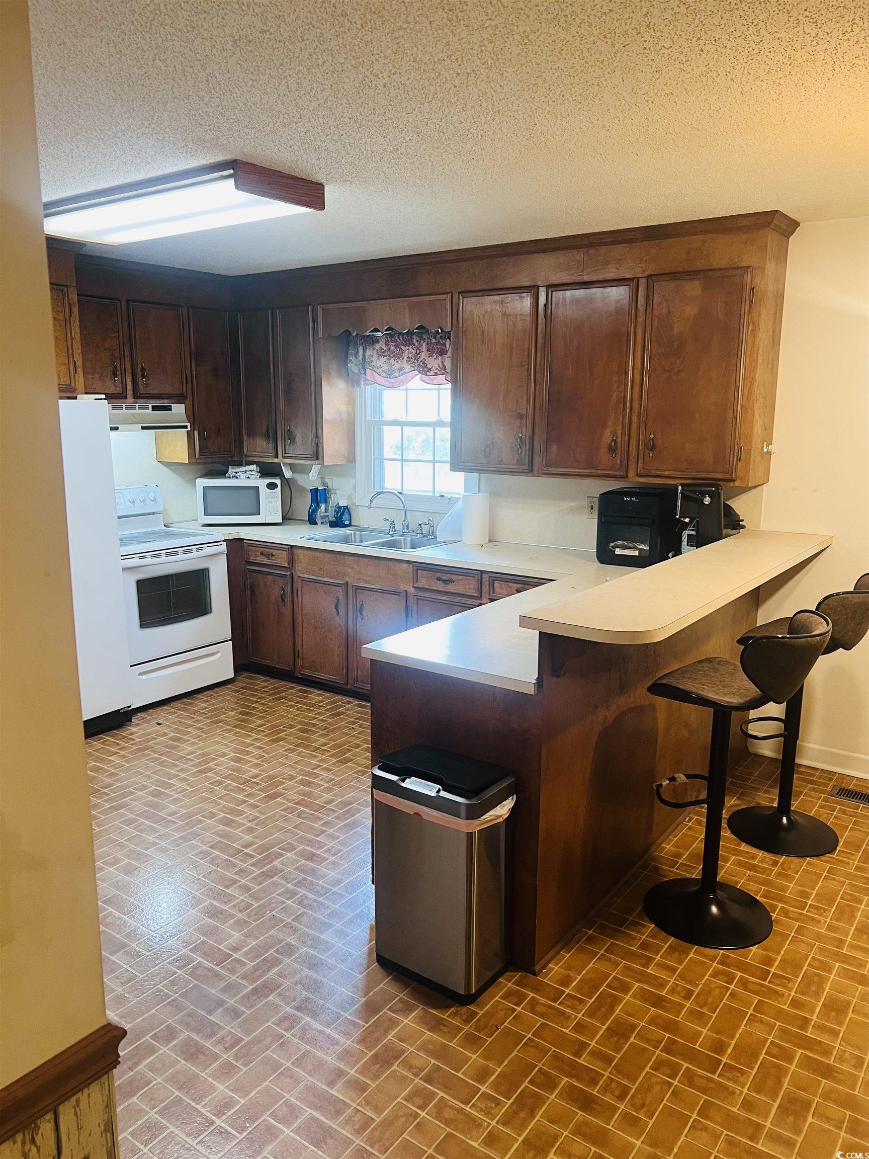 664 4 Mile Loop Cheraw, SC 29520 - Photo 11 of 27 Kitchen with brick patterned floor, extractor fan,