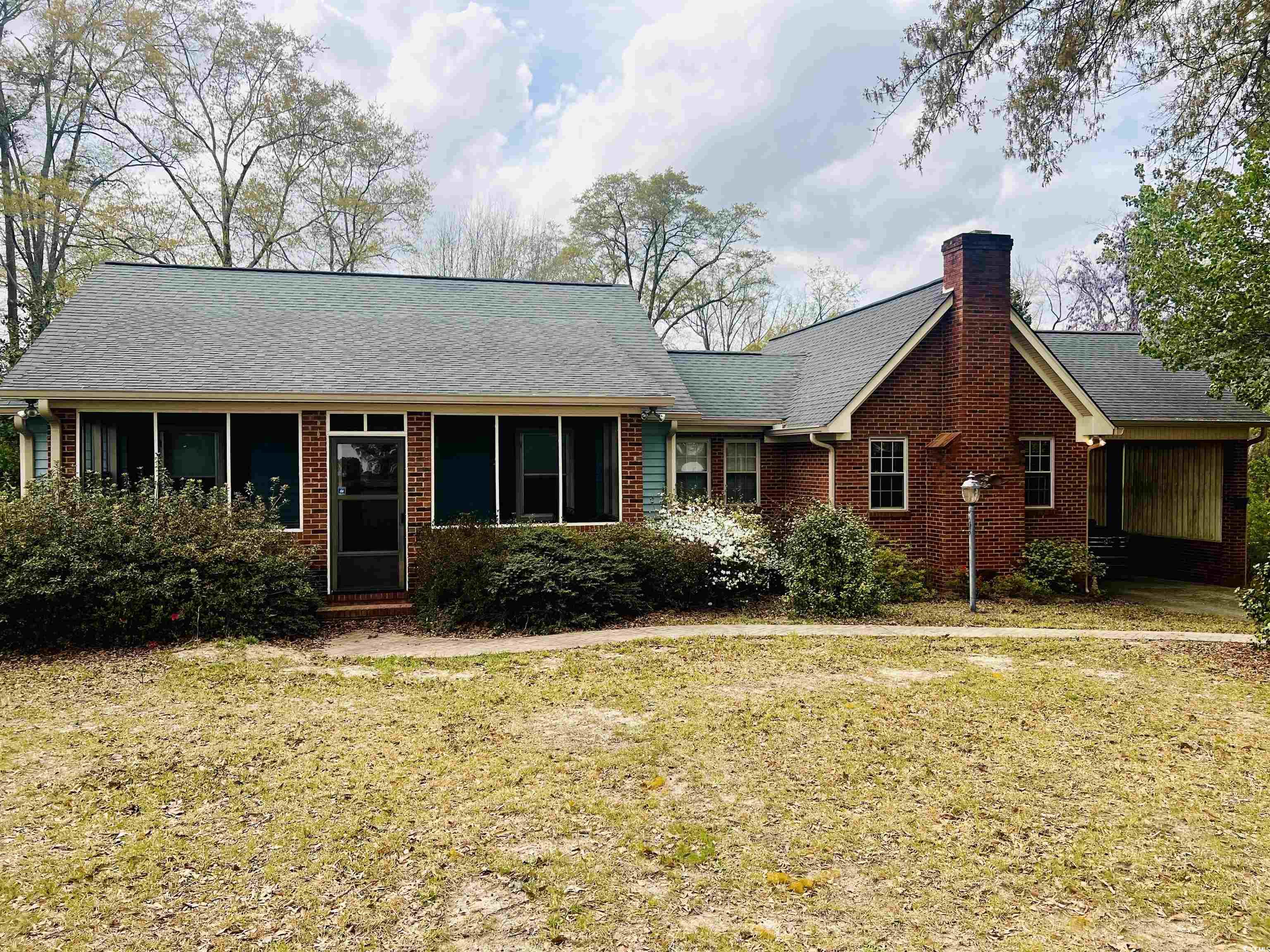 664 4 Mile Loop Cheraw, SC 29520 - Photo 2 of 27 View of front of home with a shingled roof, a chim