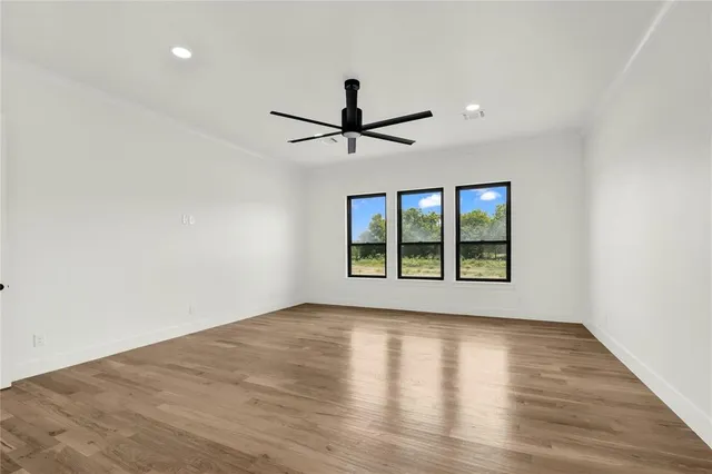 a view of a livingroom with a ceiling fan and wooden floor