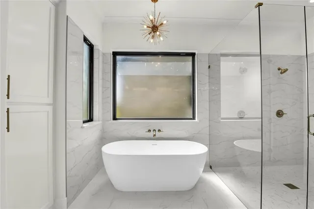 a bathroom with a bathtub and a shower