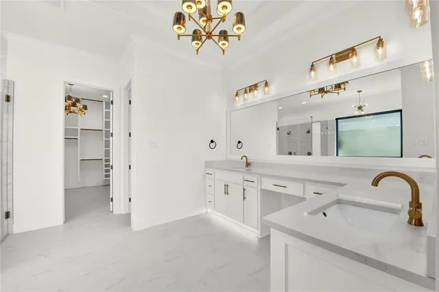 a spacious en suite bathroom with a double vanity sink