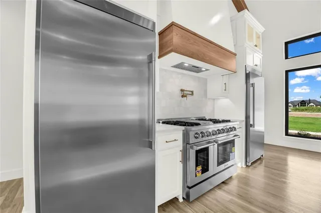 a kitchen with stainless steel appliances granite countertop a stove and a refrigerator