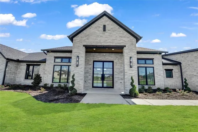 a front view of a house with a yard and porch