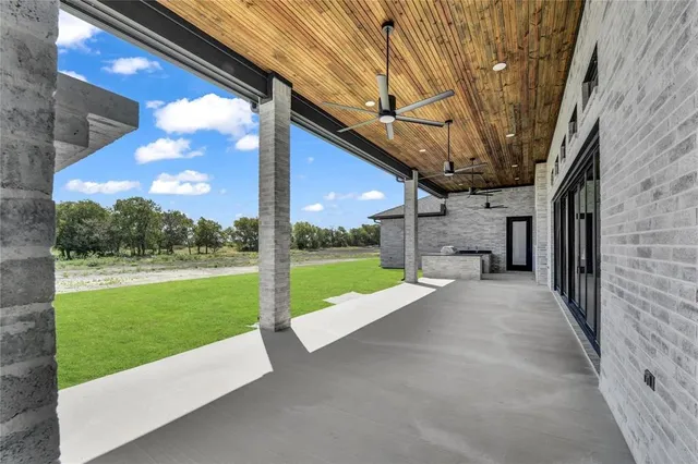 a view of a patio with a yard