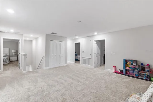 a bathroom with double vanity sinks a vanity a lamp and a mirror