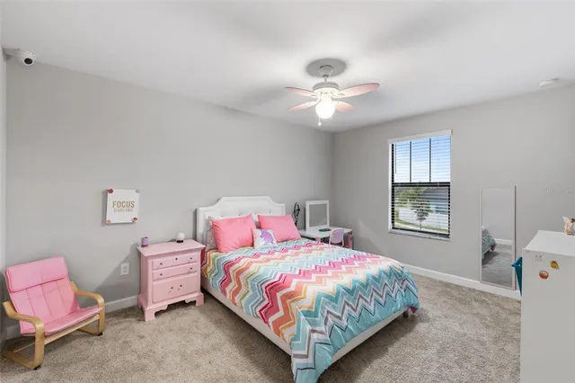a living room with furniture and ceiling fan